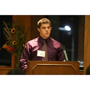 Joseph Bordieri stands behind the podium at the Torch Scholars dinner