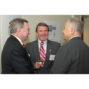 General Richard Neal converses with two other men at the Veterans Memorial dinner