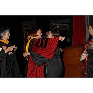 Professor Patricia Kiladis and a student hug at the School of Nursing convocation