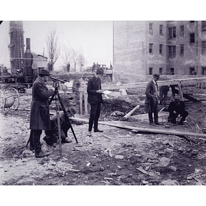 Civil engineering students surveying at construction site