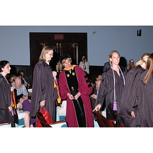 Professor Carol Glod, center, directing graduates to their seats at the School of Nursing convocation