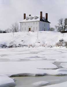 Exterior in snow from across the river, Hamilton House, South Berwick, Maine