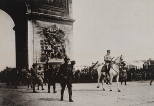 Street-level view of Marshal Philippe Pétain on a white horse passing under the Arc de Triomphe, Paris