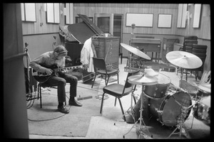 Stephen Stills, with headphones, playing an electric guitar at Wally Heider Studio 3 during production of the first Crosby, Stills, and Nash album
