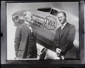 Burton Holmes and Alton H. Blackington, posed in front of a TWA airplane