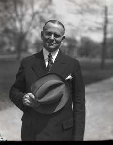 Clarence E. Jacobson, standing with hat in hand