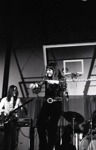 Unidentified band in performance in what appears to be a high school gymnasium: lead singer