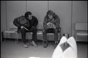 Richard Safft and man reading Free Spirit Press magazine in waiting area at JFK airport