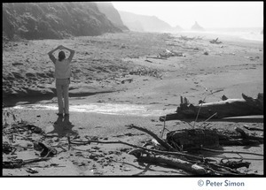 Rameshwar Das stretching on a beach in Sonoma County