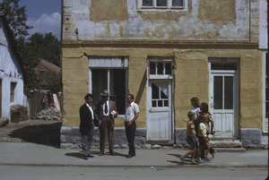 Men chatting outside shop