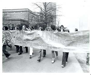 Board of Trustees fee increase demonstration: protestors holding banner, marching from the Student Union to the Whitmore Administration Building