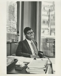 Man in a wheelchair seated at a desk