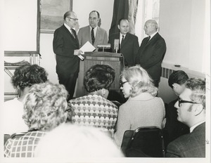 Dr. Salvatore DiMichael stands at a podium with three other men