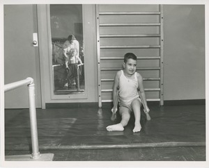 Young boy with cerebral palsy on crutches