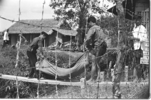 Militias recovering their dead after Vietcong attack against Duc Hoa outpost.
