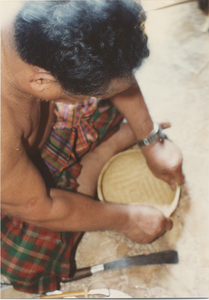 Basket Making: Em Yung shapes the basket with his hands, 1987