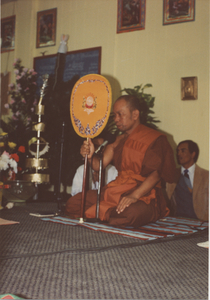 Money Tree: A monk speaks during the fundraising event, 1987