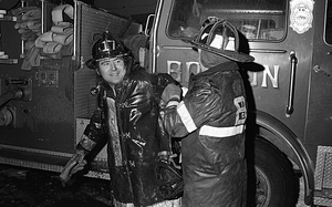 Unidentified Boston firefighters in front of fire engine