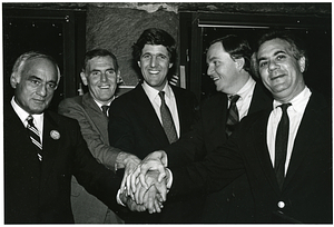 Mayor Raymond L. Flynn grasping hands with Francis X. Bellotti, John Kerry, Barney Frank and unidentified man