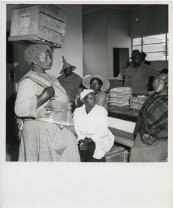 Lesotho woman demonstrates high style in carrying eggs in to the Maseru Egg Circle where they will be sold