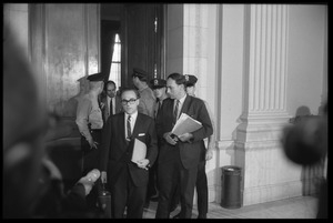 Attorney Jeremiah Gutman (?) and William Kunstler (with folders, from left) leaving the caucus room at the House Un-American Activities Committee hearings on New Left activists and the antiwar movement
