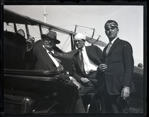 Edward Howland Robinson Green, seated with two unidentified men and biplane