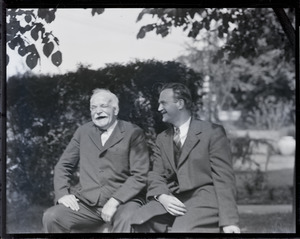 Jake Kilrain laughing, seated on a bench with Alton H. Blackington