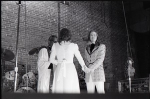 Wedding of Jim and Anne Baker: exchanging vows in front of minister and drum set