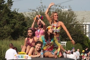 Parade marchers, dressed in beads and bright colors, on the Karaoke Funkmobile : Provincetown Carnival parade