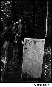 Raymond Mungo, Marty Jezer, and Michelle Clarke (l. to r.) looking at gravestones in a cemetery