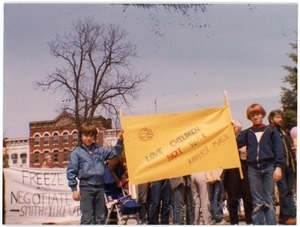 Young protesters at a Nuclear Freeze demonstration, Northampton, holding a banner reading 'Love children, not war'