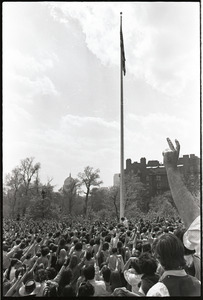 Demonstration at State House against the killings at Kent State: protesters raising fists at lowering of American flag on Boston Common