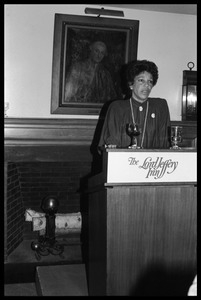 Unidentified woman speaking from a lectern at the reception for Jesse Jackson