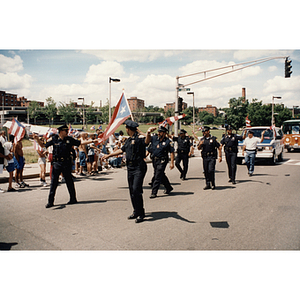 Police officers march in the Festival Puertorriqueño parade near Centre Street and Columbus Avenue. Roxbury
