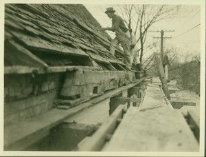 Exterior view of the roof with two workers repairing shingles, Boardman House, Saugus, Mass., undated