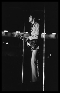 Paul McCartney (the Beatles) playing bass and singing in concert at D.C. Stadium: full-length portrait