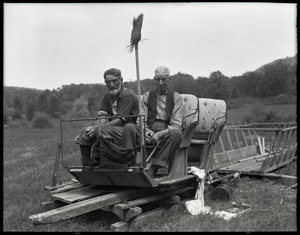 Uncle John Brooks and Ephrem Weston seated on a sled in warm weather