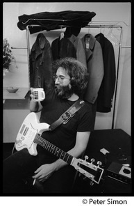 Jerry Garcia: half-length portrait seated, with a cup of coffee