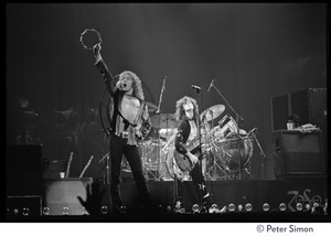 Robert Plant shaking a tambourine, on stage with Jimmy Page (guitar) in concert with Led Zeppelin at the Forum in Inglewood