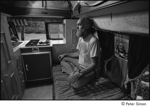 Ram Dass in his van: Ram Dass meditating next to a picture of Neem Karoli Baba