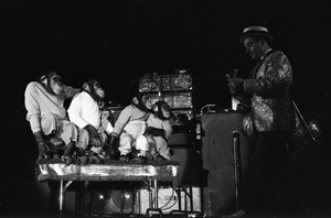 Chimpanzee vaudeville act opening for the Grateful Dead at Sargent Gym, Boston University: performer with pork-pie hat and chimpanzees