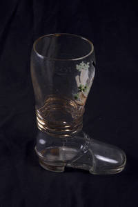 A blown glass boot with gymnastic scene