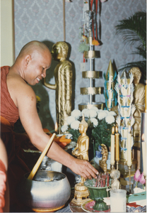 Consecration: Venerable Sao Khon places a burning stick of incense, 1987