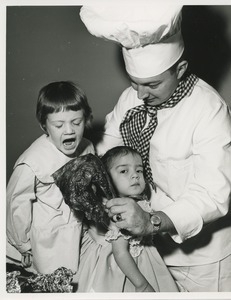 Chef and two young girls posing with turkey