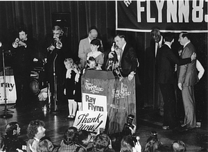 Mayor Raymond L. Flynn at the podium at the Boston Park Plaza Hotel with his wife, Catherine (Kathy), and four daughters after winning the 1983 mayoral election