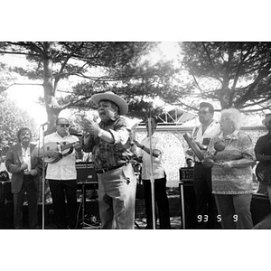 Singer and musicians performing on outdoor stage in Plaza Betances.