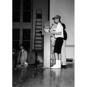 Unidentified teenage boy at the microphone on the stage at the Jorge Hernandez Cultural Center.