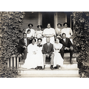Family portrait, family of twelve on house steps