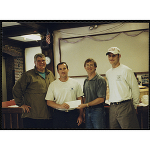 Jerry Steimel, Charlestown Clubhouse Director, standing third from left, accepts a check from an unidentified group of men