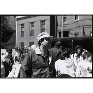 A man wearing a hat, facing right, standing outside at the Boys and Girls Clubs of Boston 100th Anniversary Celebration Street Fair